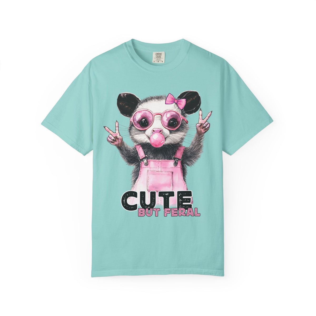 Cute But Feral, Possum in Pink Bibs - Comfort Colors | Trendy Women's T-Shirt. Direct to Garment. Printed & Shipped in the USA. Unisex Sizes.