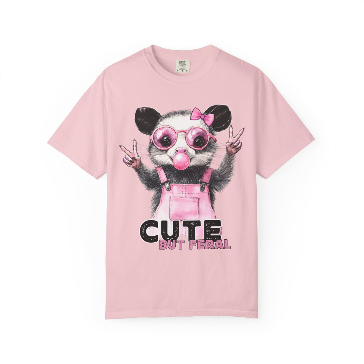 Cute But Feral, Possum in Pink Bibs - Comfort Colors | Trendy Women's T-Shirt. Direct to Garment. Printed & Shipped in the USA. Unisex Sizes.