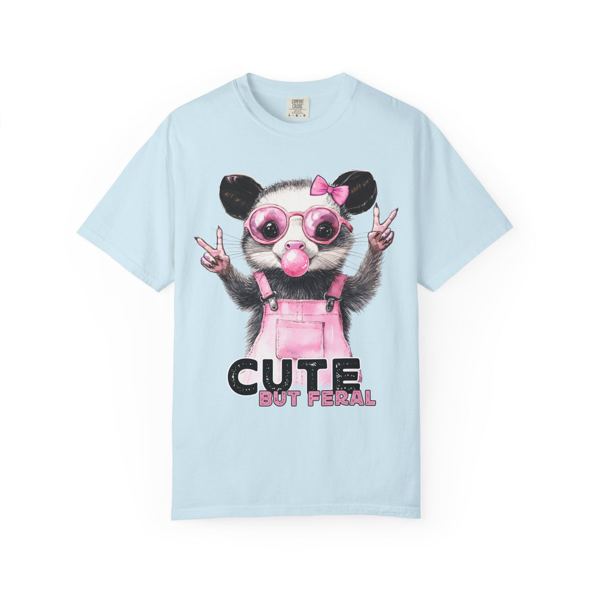 Cute But Feral, Possum in Pink Bibs - Comfort Colors | Trendy Women's T-Shirt. Direct to Garment. Printed & Shipped in the USA. Unisex Sizes.
