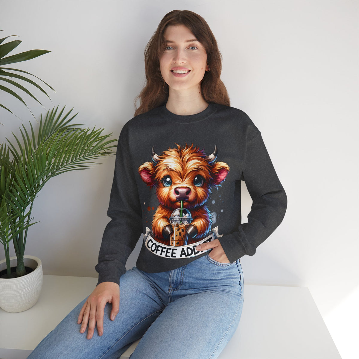 Coffee Addict Highland Cow Drinking Iced Coffee – Gildan Heavy Blend | Trendy Women’s Soft Sweatshirt. Direct to Garment. Printed & Shipped in the USA. Unisex Sizes.