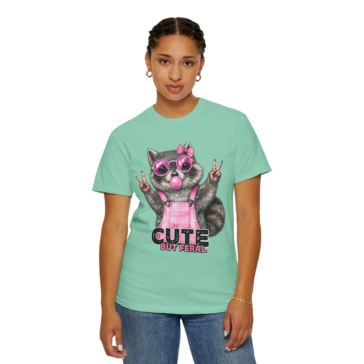 Cute But Feral, Raccoon in Pink Bibs - Comfort Colors | Trendy Women's T-Shirt. Direct to Garment. Printed & Shipped in the USA. Unisex Sizes.