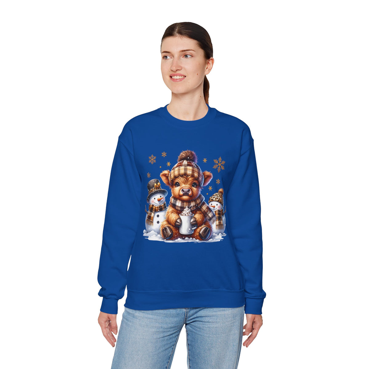 Cute Highland Cow with Snowmen, Winter – Gildan Heavy Blend | Trendy Women’s Soft Sweatshirt. Direct to Garment. Printed & Shipped in the USA. Unisex Sizes.