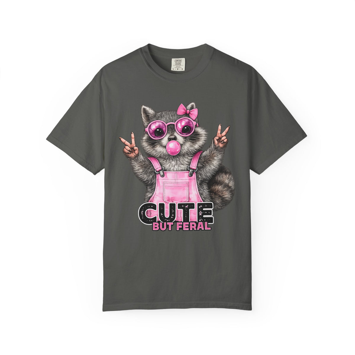 Cute But Feral, Raccoon in Pink Bibs - Comfort Colors | Trendy Women's T-Shirt. Direct to Garment. Printed & Shipped in the USA. Unisex Sizes.