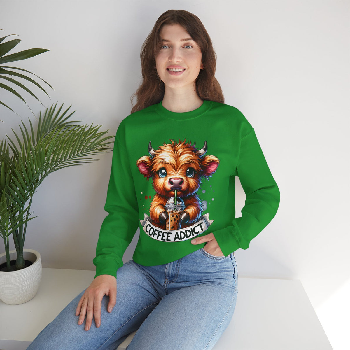 Coffee Addict Highland Cow Drinking Iced Coffee – Gildan Heavy Blend | Trendy Women’s Soft Sweatshirt. Direct to Garment. Printed & Shipped in the USA. Unisex Sizes.