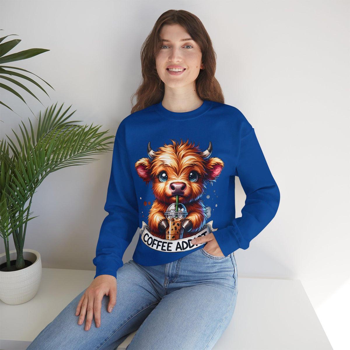 Coffee Addict Highland Cow Drinking Iced Coffee – Gildan Heavy Blend | Trendy Women’s Soft Sweatshirt. Direct to Garment. Printed & Shipped in the USA. Unisex Sizes.