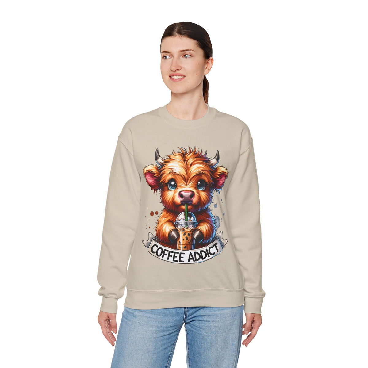 Coffee Addict Highland Cow Drinking Iced Coffee – Gildan Heavy Blend | Trendy Women’s Soft Sweatshirt. Direct to Garment. Printed & Shipped in the USA. Unisex Sizes.