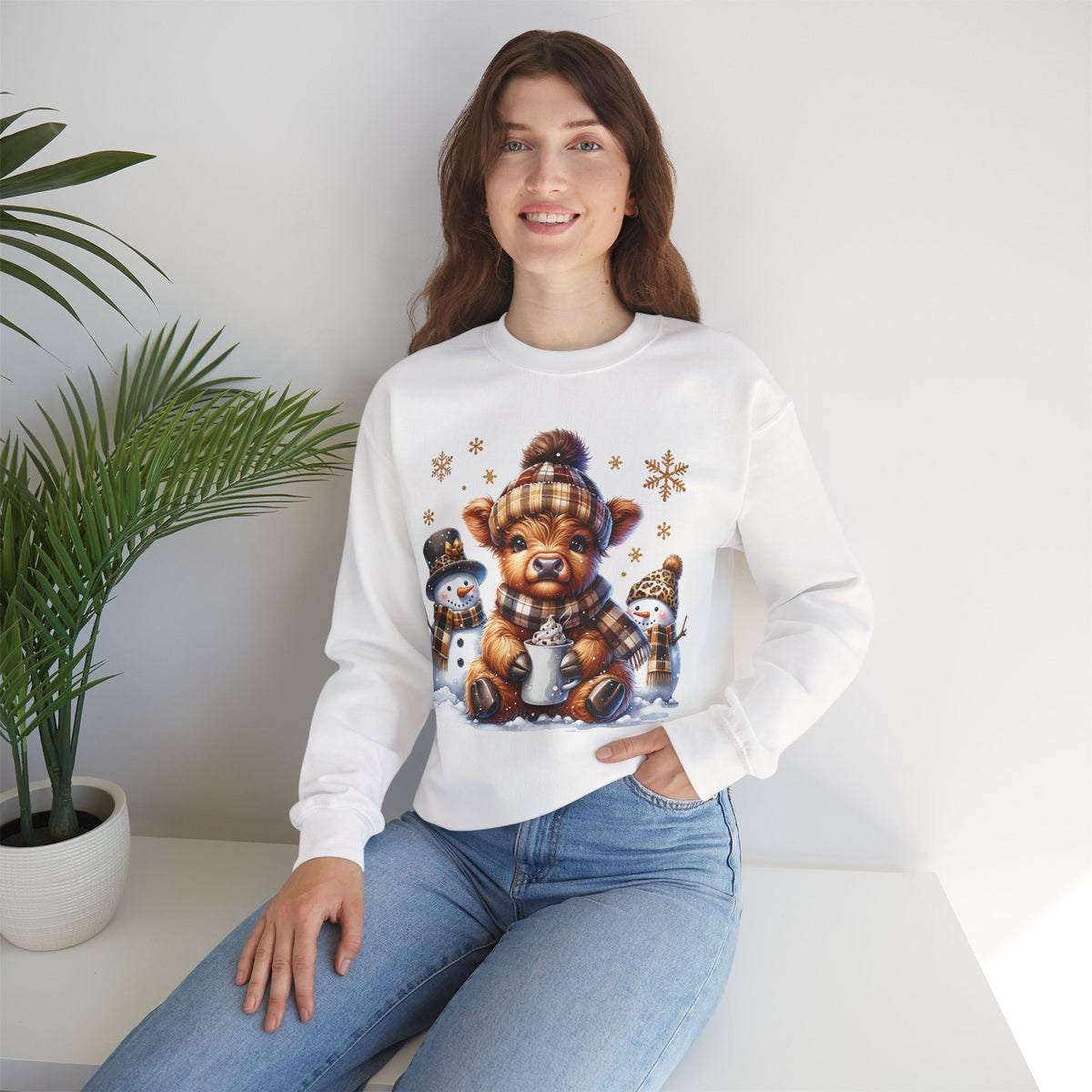 Cute Highland Cow with Snowmen, Winter – Gildan Heavy Blend | Trendy Women’s Soft Sweatshirt. Direct to Garment. Printed & Shipped in the USA. Unisex Sizes.