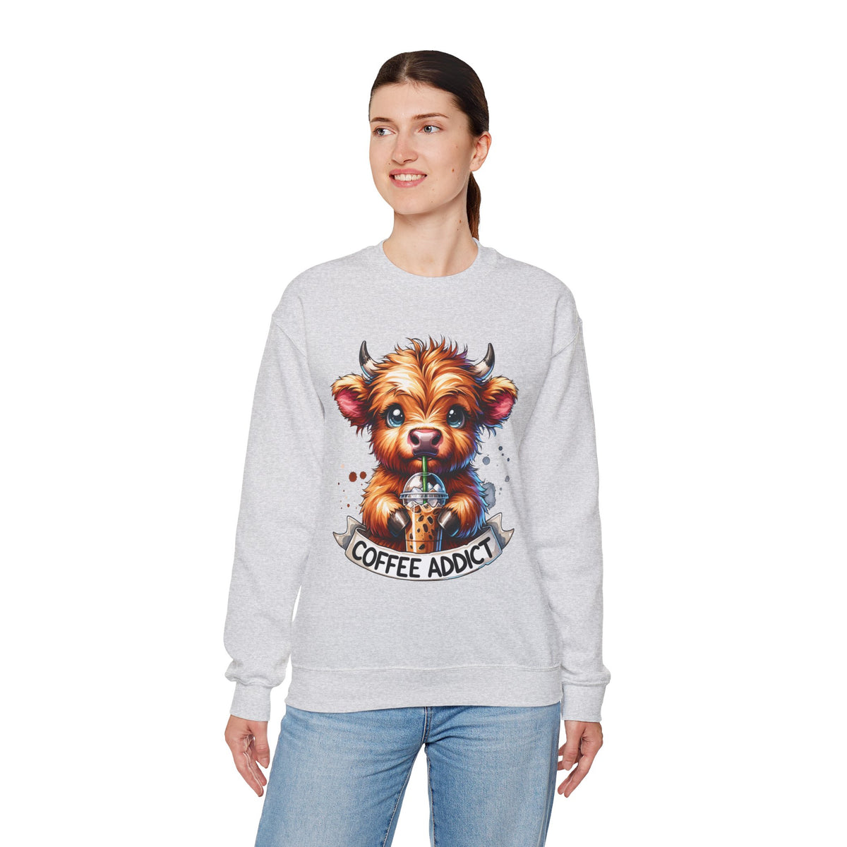Coffee Addict Highland Cow Drinking Iced Coffee – Gildan Heavy Blend | Trendy Women’s Soft Sweatshirt. Direct to Garment. Printed & Shipped in the USA. Unisex Sizes.