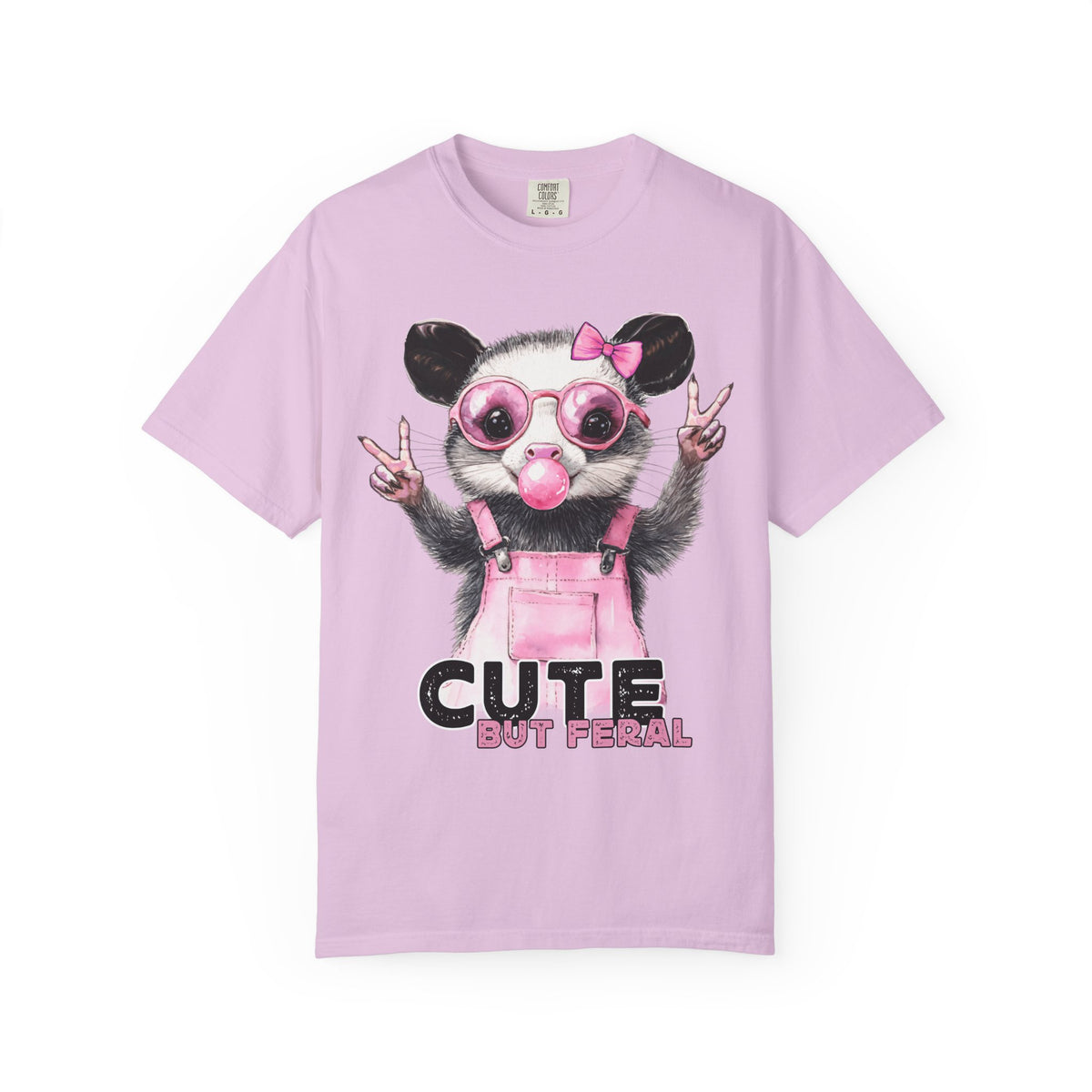 Cute But Feral, Possum in Pink Bibs - Comfort Colors | Trendy Women's T-Shirt. Direct to Garment. Printed & Shipped in the USA. Unisex Sizes.