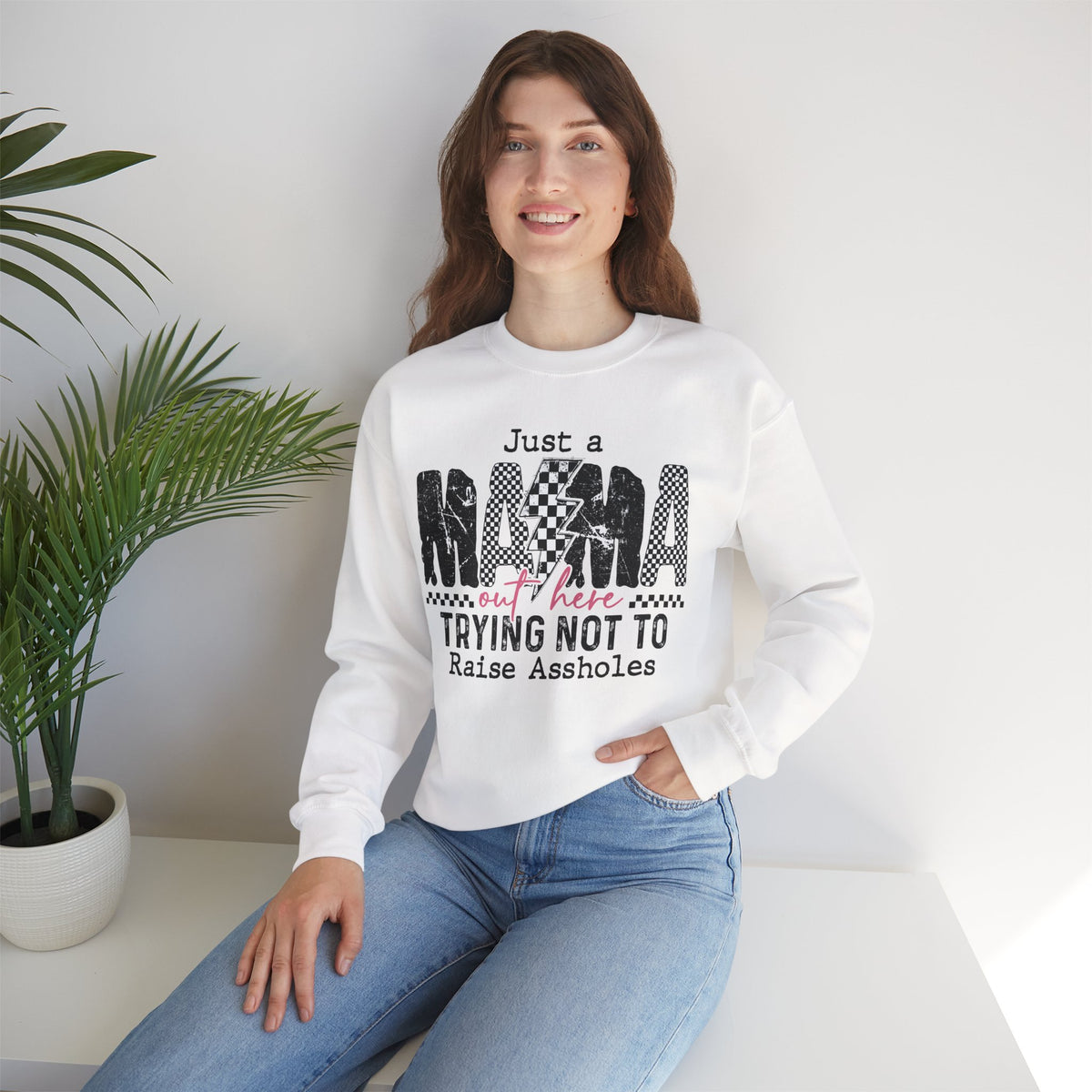 Just a Mama Out Here Trying Not To Raise Assholes – Gildan Heavy Blend | Trendy Women’s Soft Sweatshirt. Direct to Garment. Printed & Shipped in the USA. Unisex Sizes.