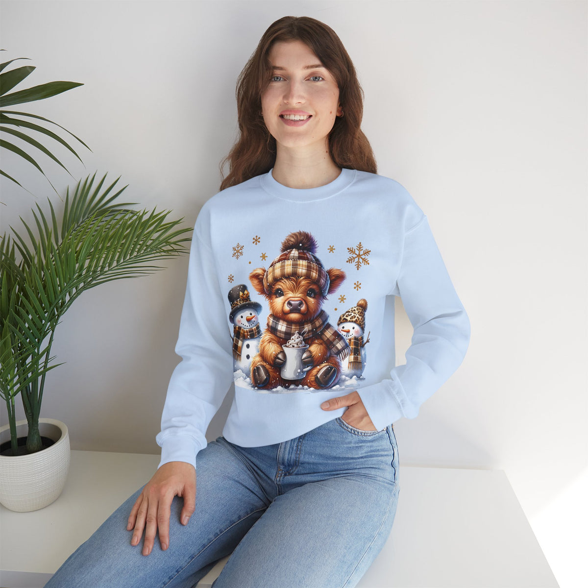 Cute Highland Cow with Snowmen, Winter – Gildan Heavy Blend | Trendy Women’s Soft Sweatshirt. Direct to Garment. Printed & Shipped in the USA. Unisex Sizes.