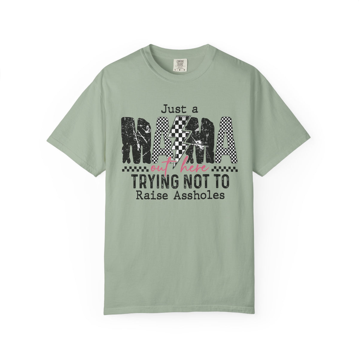 Just a Mama Out Here Trying Not To Raise Assholes - Comfort Colors | Trendy Women's T-Shirt. Direct to Garment. Printed & Shipped in the USA. Unisex Sizes.