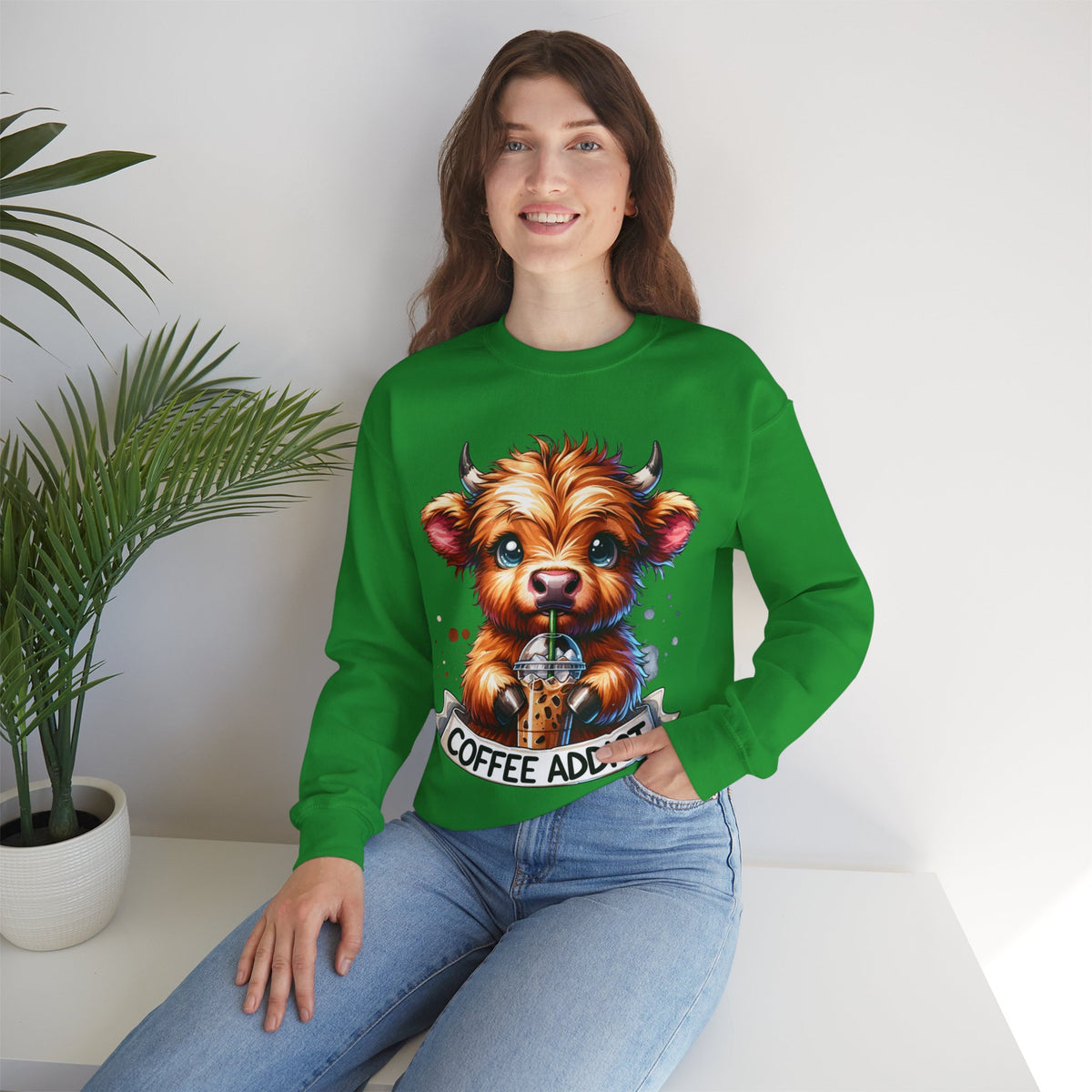 Coffee Addict Highland Cow Drinking Iced Coffee – Gildan Heavy Blend | Trendy Women’s Soft Sweatshirt. Direct to Garment. Printed & Shipped in the USA. Unisex Sizes.