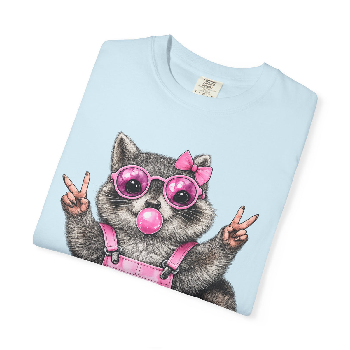 Cute But Feral, Raccoon in Pink Bibs - Comfort Colors | Trendy Women's T-Shirt. Direct to Garment. Printed & Shipped in the USA. Unisex Sizes.