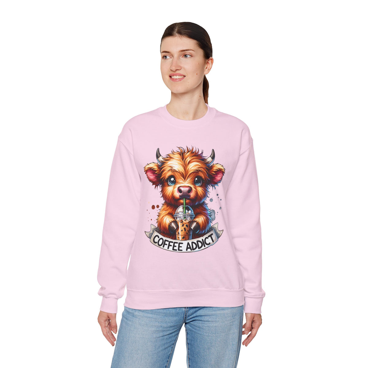 Coffee Addict Highland Cow Drinking Iced Coffee – Gildan Heavy Blend | Trendy Women’s Soft Sweatshirt. Direct to Garment. Printed & Shipped in the USA. Unisex Sizes.