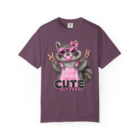 Cute But Feral, Raccoon in Pink Bibs - Comfort Colors | Trendy Women's T-Shirt. Direct to Garment. Printed & Shipped in the USA. Unisex Sizes.