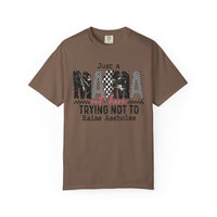 Just a Mama Out Here Trying Not To Raise Assholes - Comfort Colors | Trendy Women's T-Shirt. Direct to Garment. Printed & Shipped in the USA. Unisex Sizes.