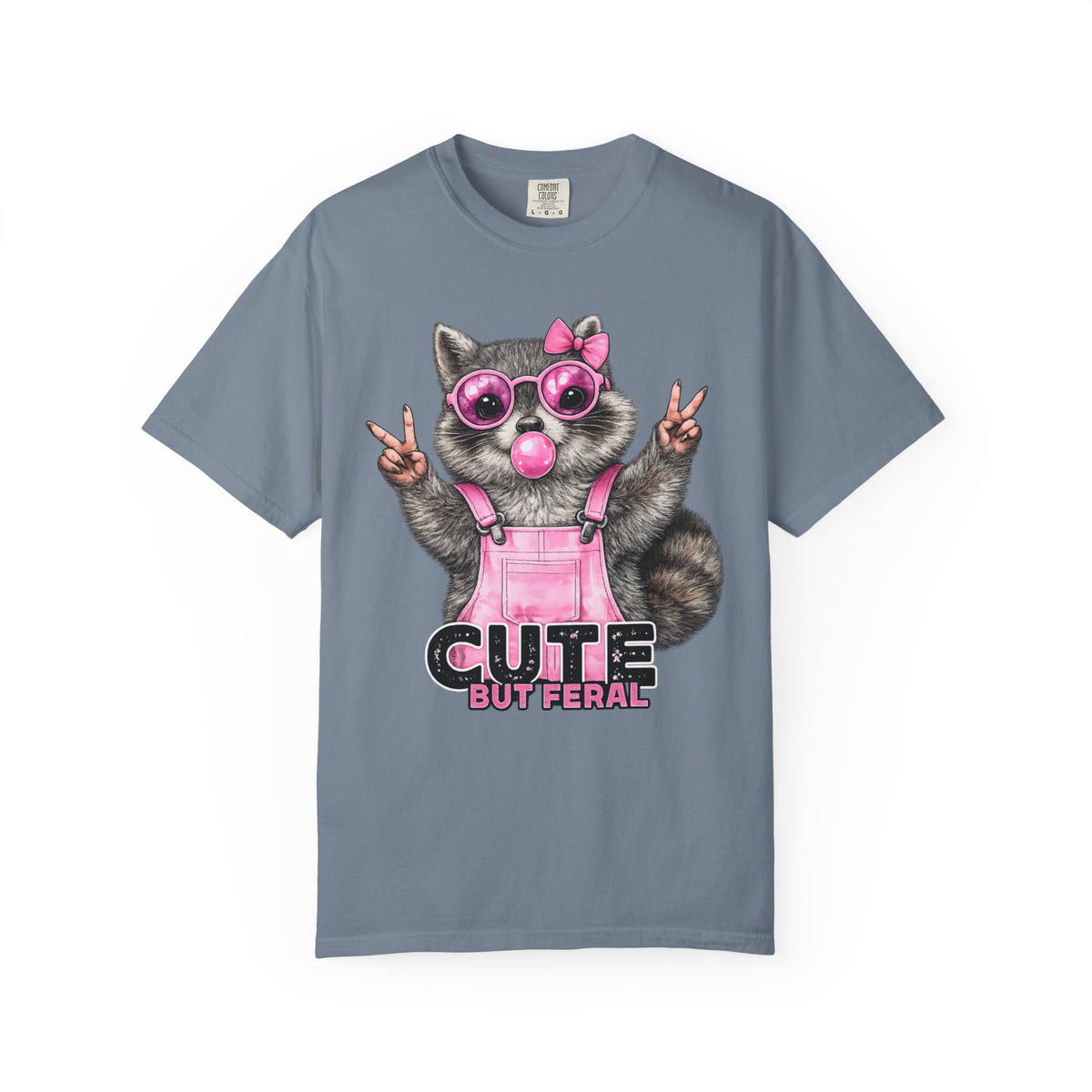 Cute But Feral, Raccoon in Pink Bibs - Comfort Colors | Trendy Women's T-Shirt. Direct to Garment. Printed & Shipped in the USA. Unisex Sizes.