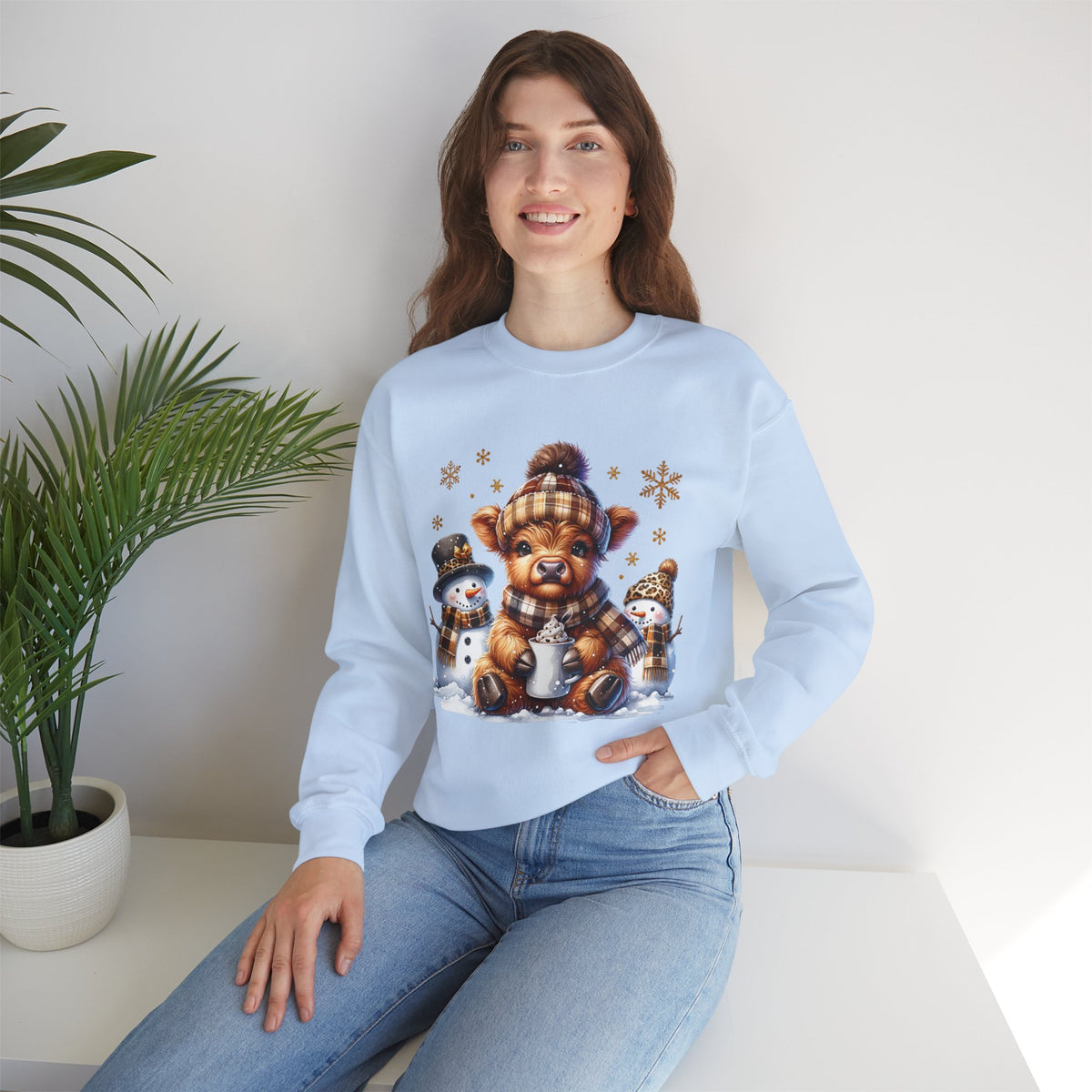 Cute Highland Cow with Snowmen, Winter – Gildan Heavy Blend | Trendy Women’s Soft Sweatshirt. Direct to Garment. Printed & Shipped in the USA. Unisex Sizes.
