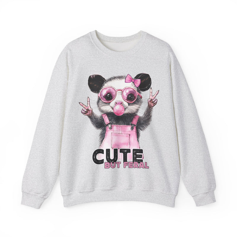 Cute But Feral, Possum in Pink Bibs – Gildan Heavy Blend | Trendy Women’s Soft Sweatshirt. Direct to Garment. Printed & Shipped in the USA. Unisex Sizes.