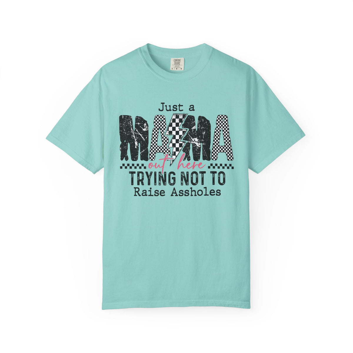 Just a Mama Out Here Trying Not To Raise Assholes - Comfort Colors | Trendy Women's T-Shirt. Direct to Garment. Printed & Shipped in the USA. Unisex Sizes.
