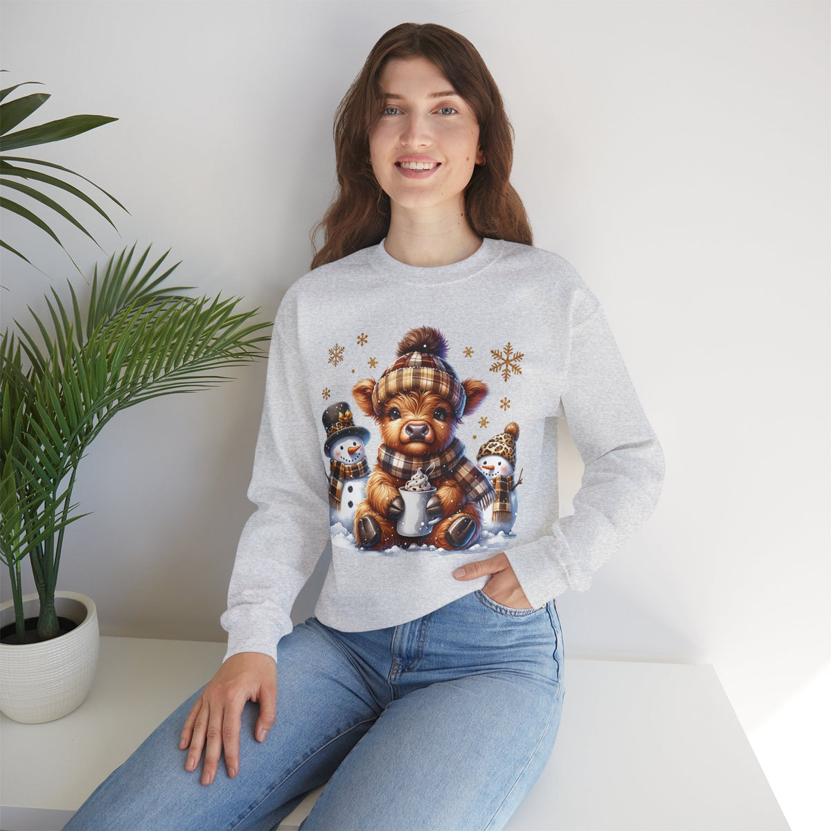 Cute Highland Cow with Snowmen, Winter – Gildan Heavy Blend | Trendy Women’s Soft Sweatshirt. Direct to Garment. Printed & Shipped in the USA. Unisex Sizes.