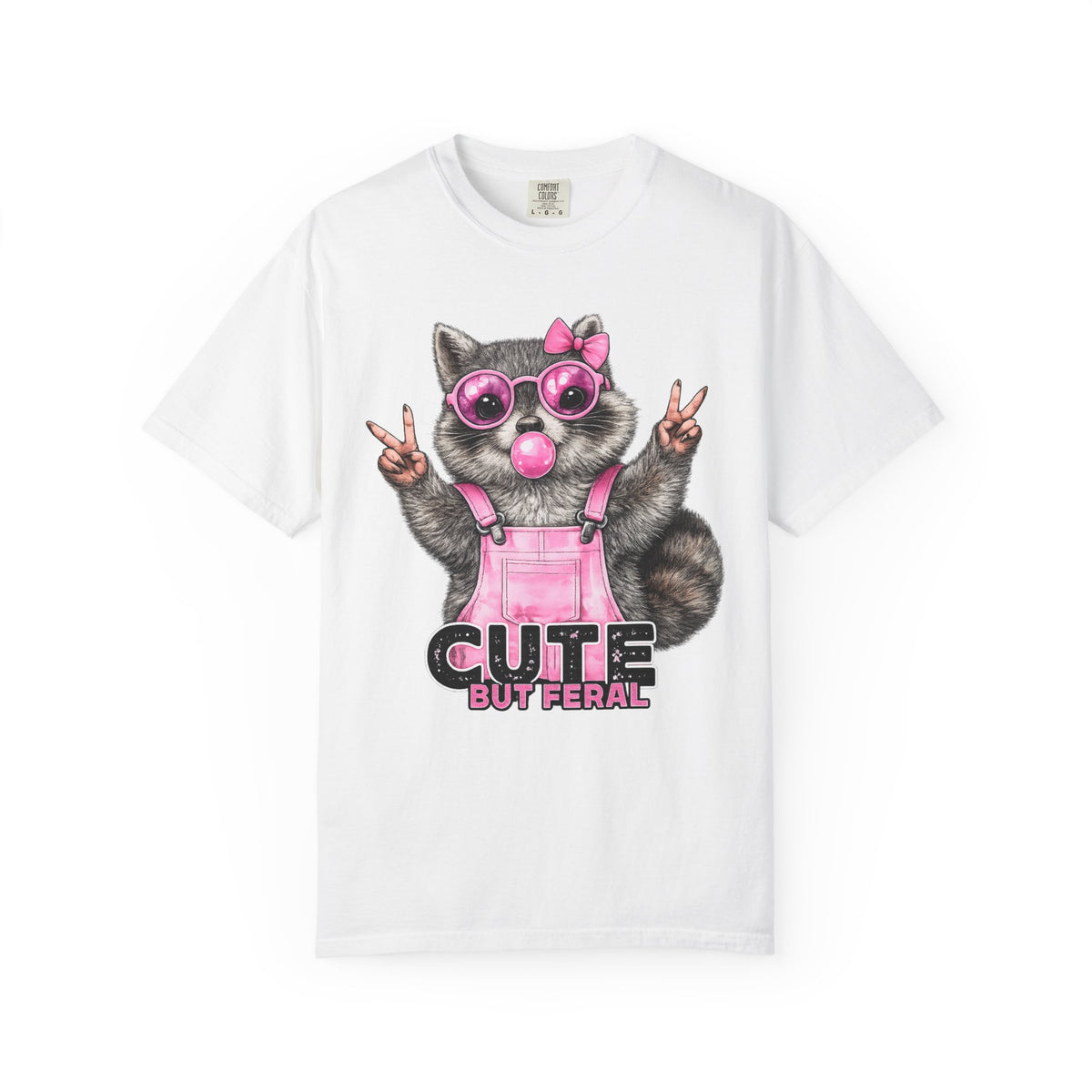 Cute But Feral, Raccoon in Pink Bibs - Comfort Colors | Trendy Women's T-Shirt. Direct to Garment. Printed & Shipped in the USA. Unisex Sizes.