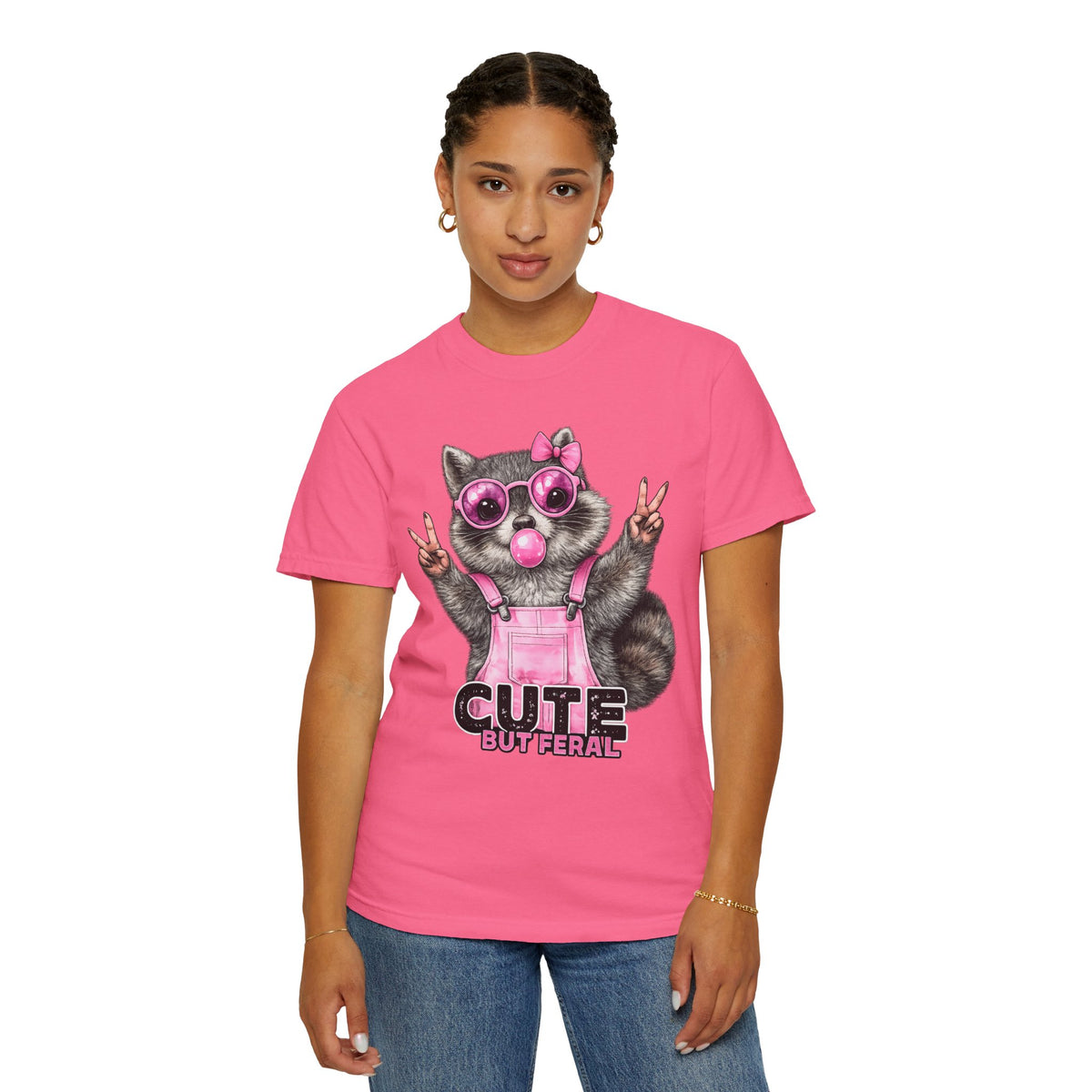 Cute But Feral, Raccoon in Pink Bibs - Comfort Colors | Trendy Women's T-Shirt. Direct to Garment. Printed & Shipped in the USA. Unisex Sizes.