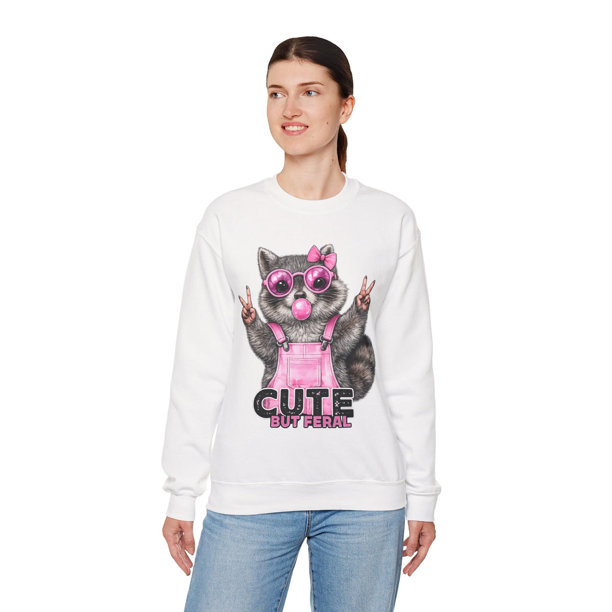 Cute But Feral, Raccoon in Pink Bibs – Gildan Heavy Blend | Trendy Women’s Soft Sweatshirt. Direct to Garment. Printed & Shipped in the USA. Unisex Sizes.