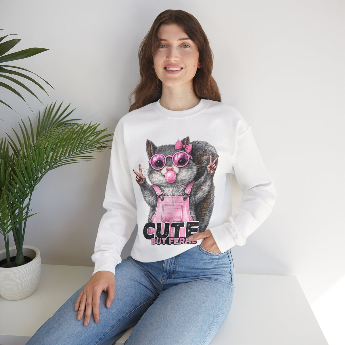Cute But Feral, Squirrel in Pink Bibs – Gildan Heavy Blend | Trendy Women’s Soft Sweatshirt. Direct to Garment. Printed & Shipped in the USA. Unisex Sizes.