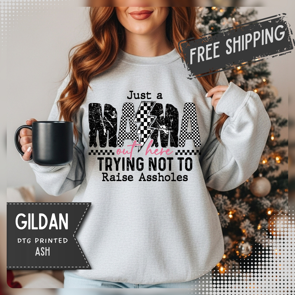Just a Mama Out Here Trying Not To Raise Assholes – Gildan Heavy Blend | Trendy Women’s Soft Sweatshirt. Direct to Garment. Printed & Shipped in the USA. Unisex Sizes.