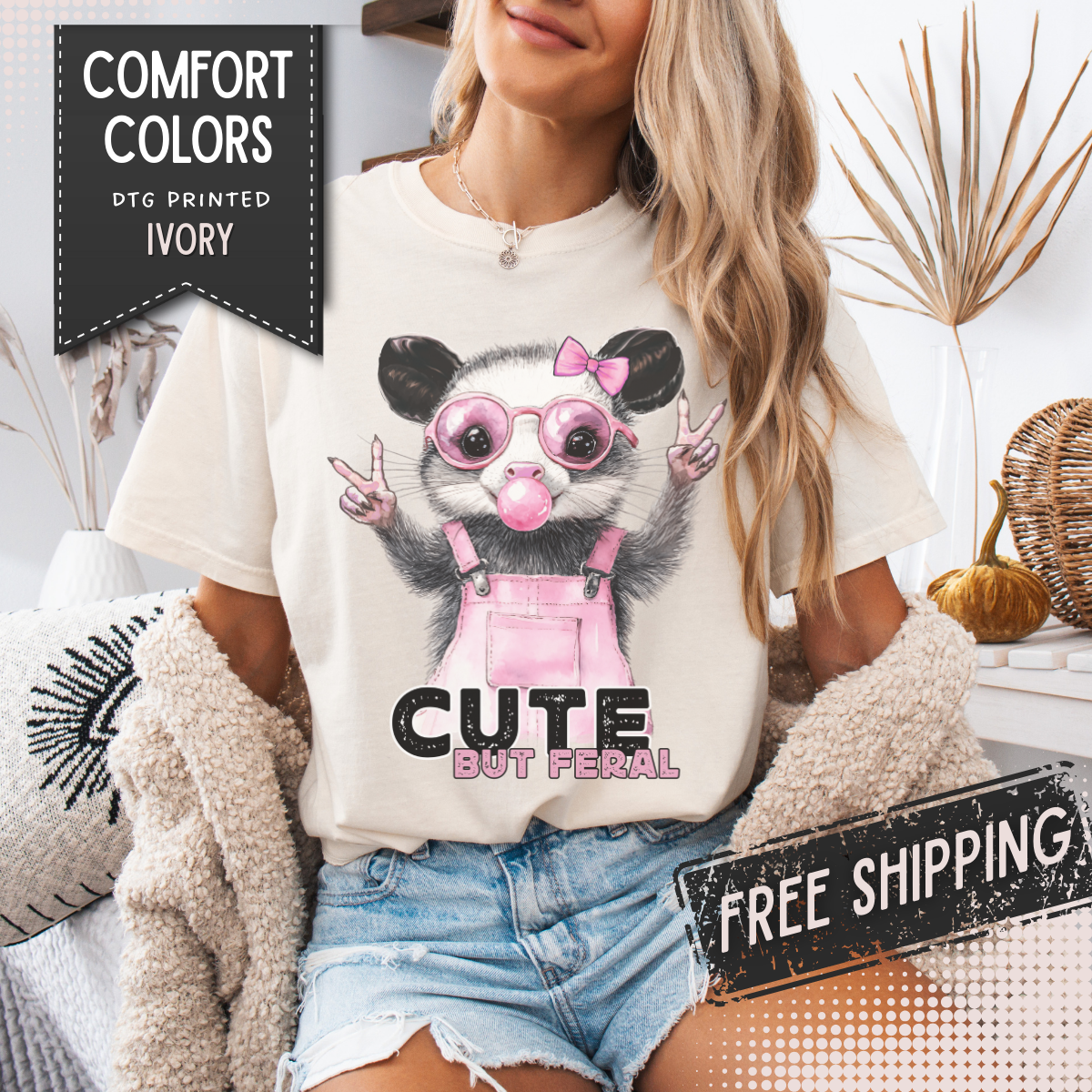 Cute But Feral, Possum in Pink Bibs - Comfort Colors | Trendy Women's T-Shirt. Direct to Garment. Printed & Shipped in the USA. Unisex Sizes.