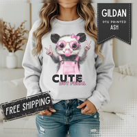 Cute But Feral, Possum in Pink Bibs – Gildan Heavy Blend | Trendy Women’s Soft Sweatshirt. Direct to Garment. Printed & Shipped in the USA. Unisex Sizes.