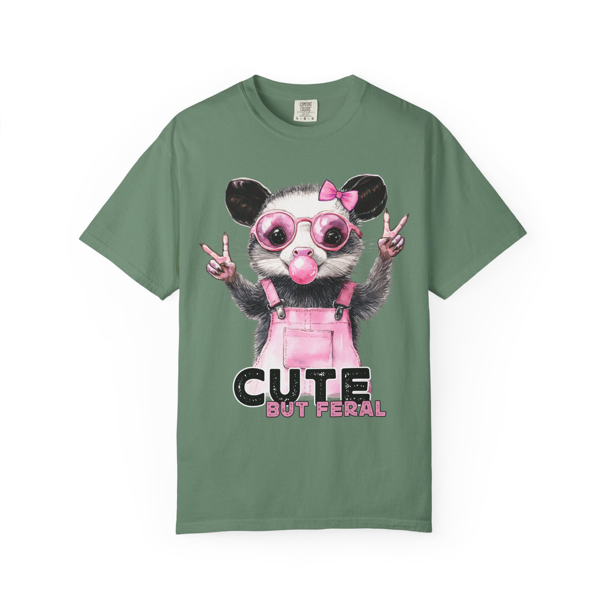Cute But Feral, Possum in Pink Bibs - Comfort Colors | Trendy Women's T-Shirt. Direct to Garment. Printed & Shipped in the USA. Unisex Sizes.