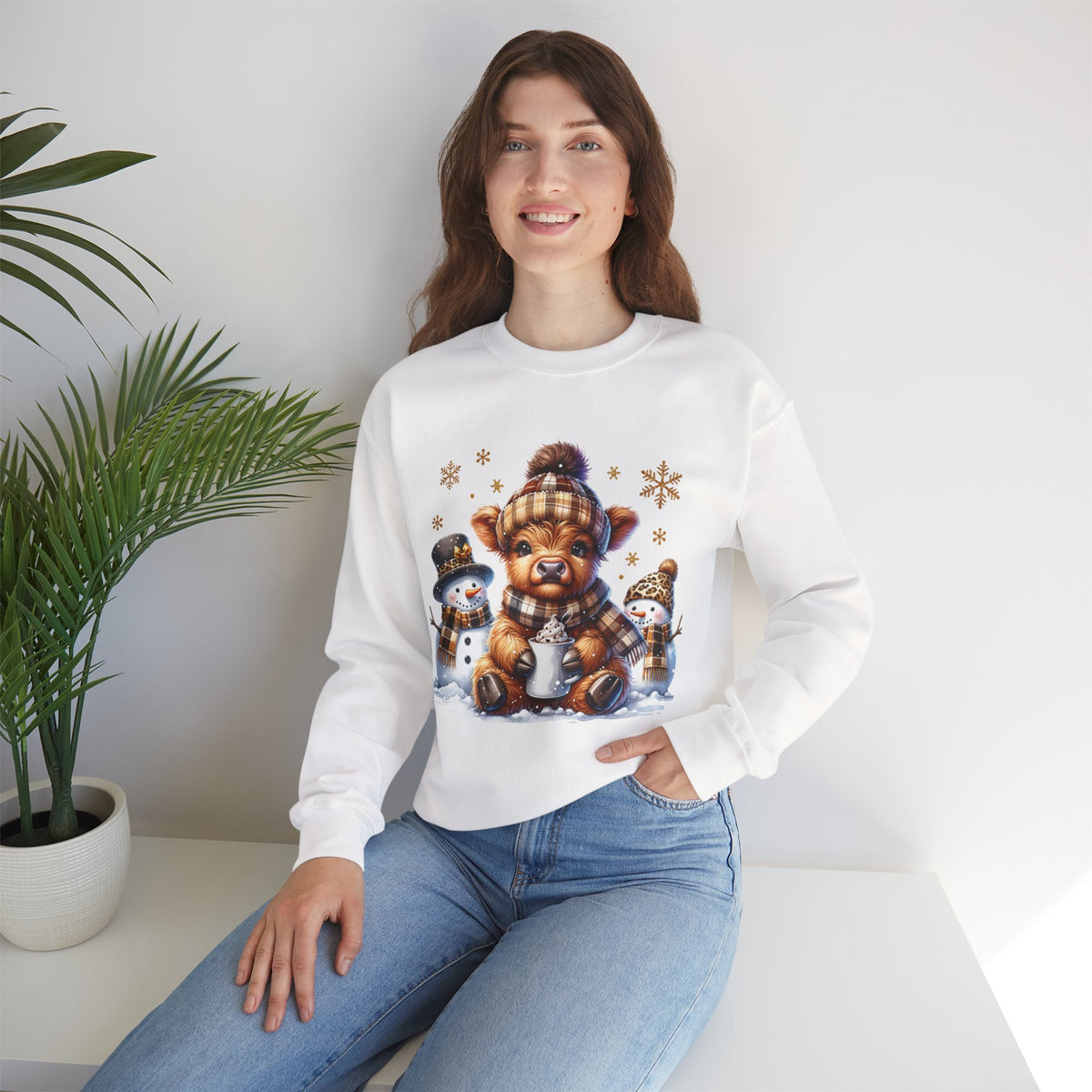 Cute Highland Cow with Snowmen, Winter – Gildan Heavy Blend | Trendy Women’s Soft Sweatshirt. Direct to Garment. Printed & Shipped in the USA. Unisex Sizes.