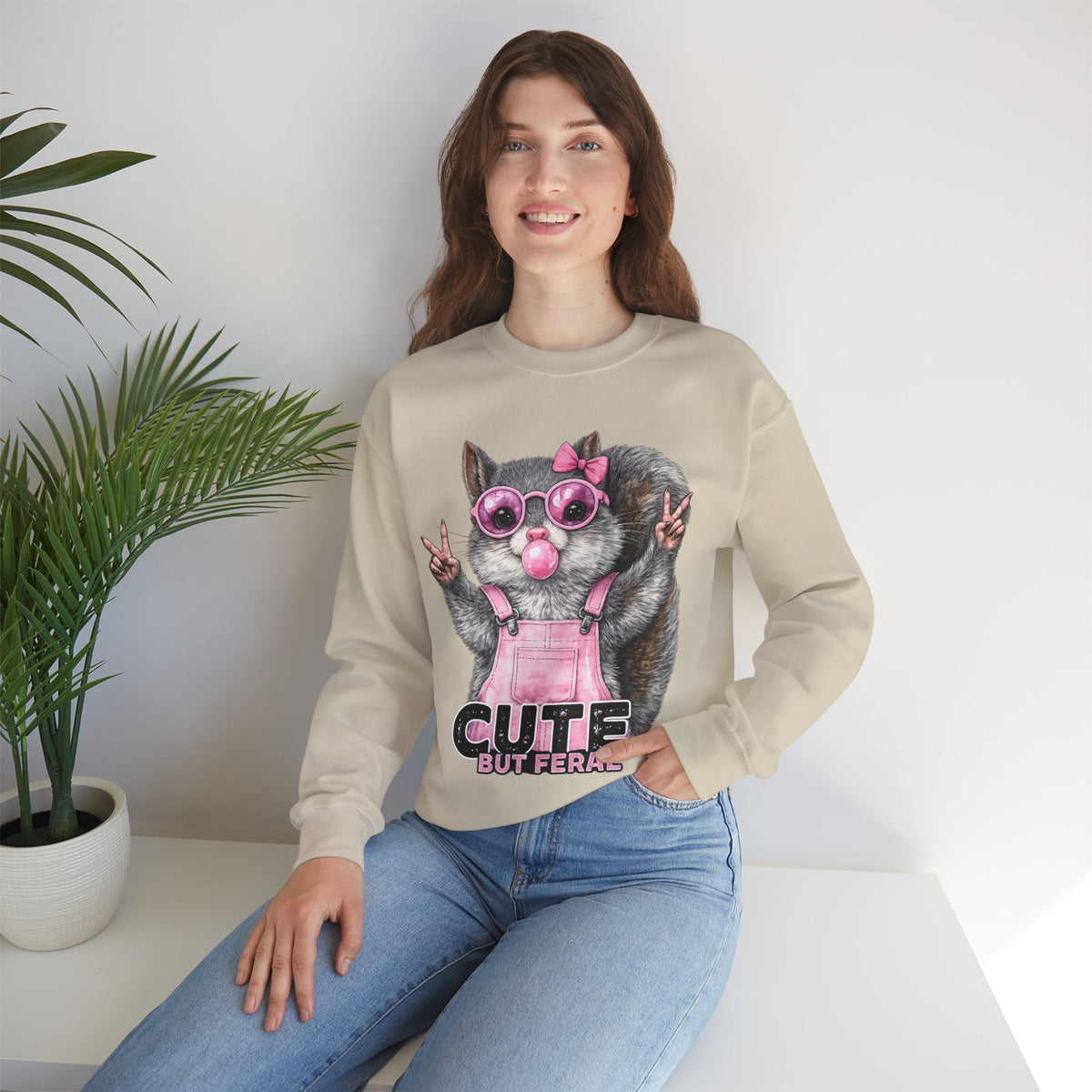 Cute But Feral, Squirrel in Pink Bibs – Gildan Heavy Blend | Trendy Women’s Soft Sweatshirt. Direct to Garment. Printed & Shipped in the USA. Unisex Sizes.
