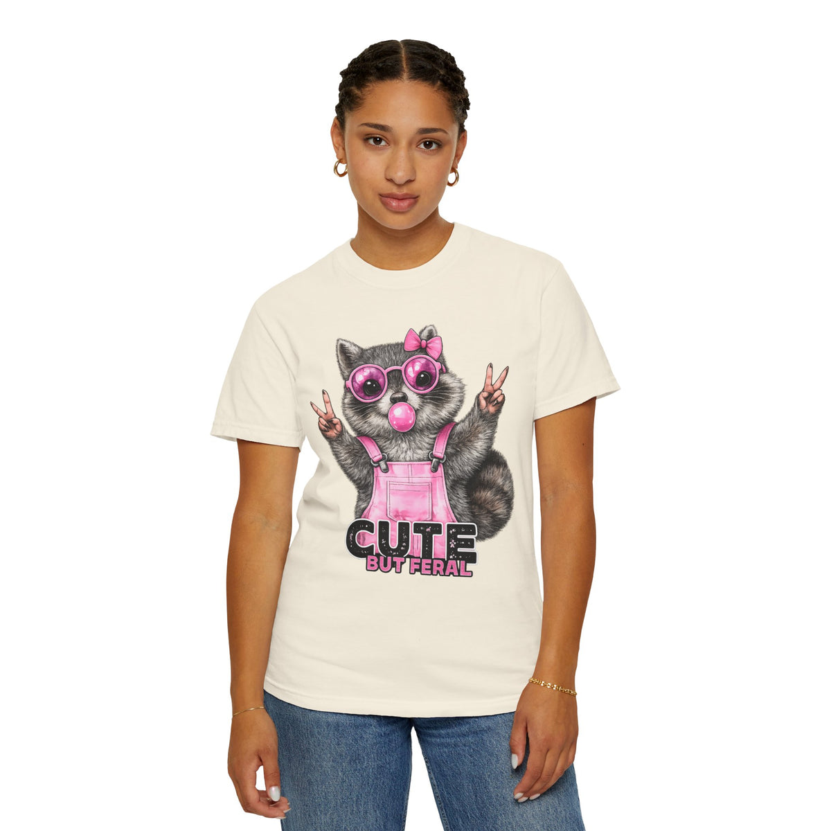 Cute But Feral, Raccoon in Pink Bibs - Comfort Colors | Trendy Women's T-Shirt. Direct to Garment. Printed & Shipped in the USA. Unisex Sizes.