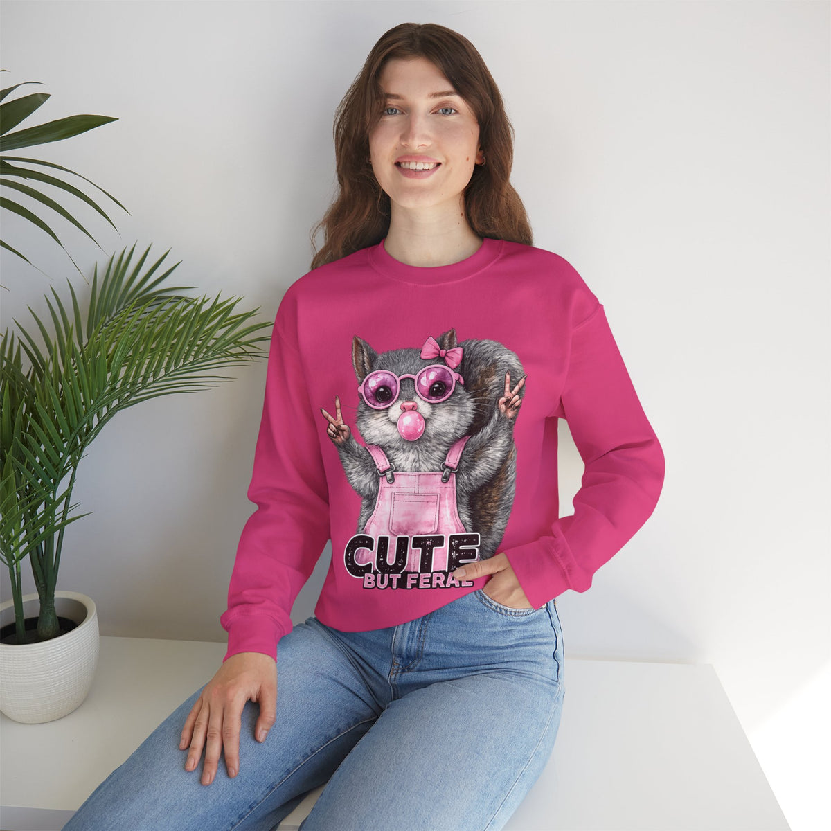 Cute But Feral, Squirrel in Pink Bibs – Gildan Heavy Blend | Trendy Women’s Soft Sweatshirt. Direct to Garment. Printed & Shipped in the USA. Unisex Sizes.