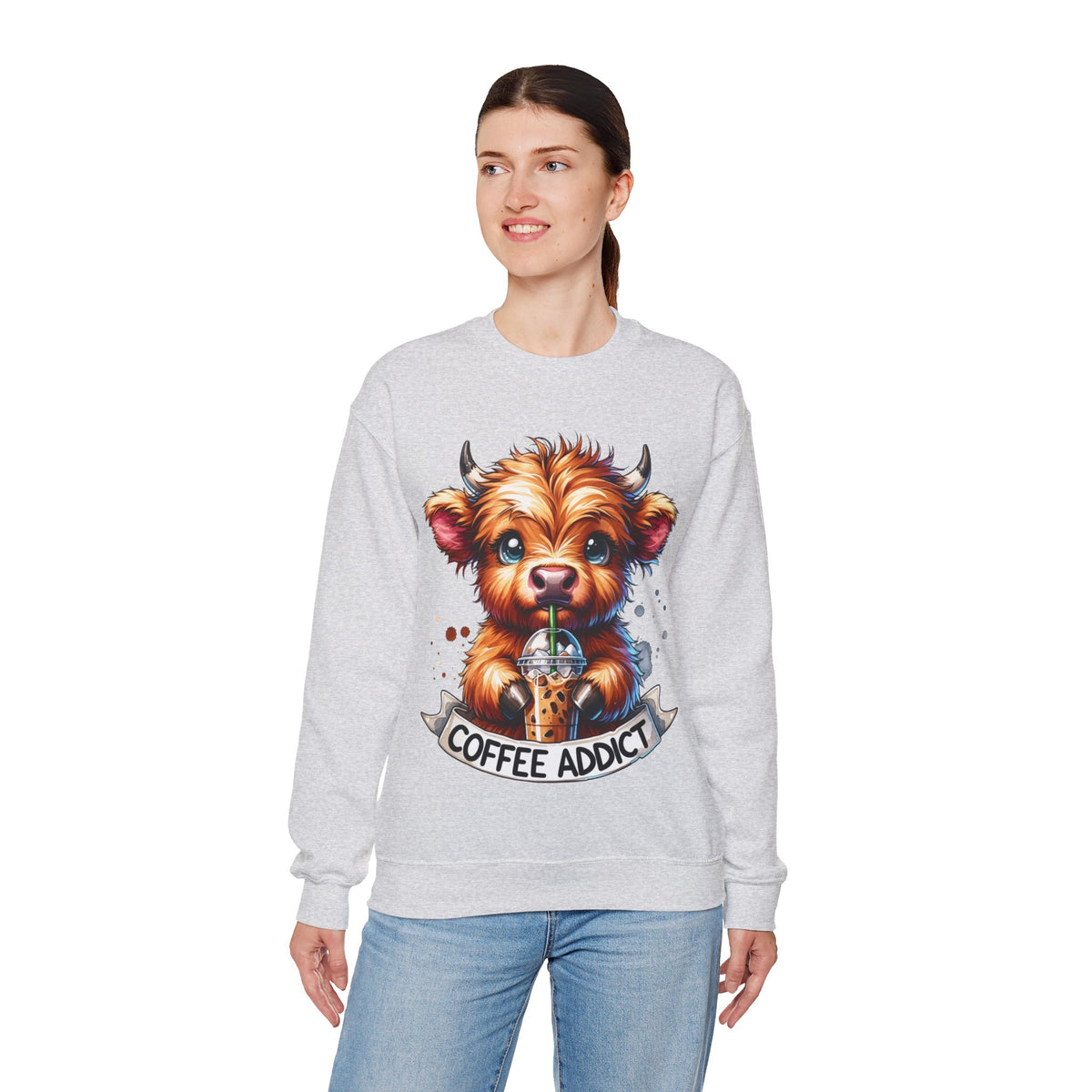 Coffee Addict Highland Cow Drinking Iced Coffee – Gildan Heavy Blend | Trendy Women’s Soft Sweatshirt. Direct to Garment. Printed & Shipped in the USA. Unisex Sizes.