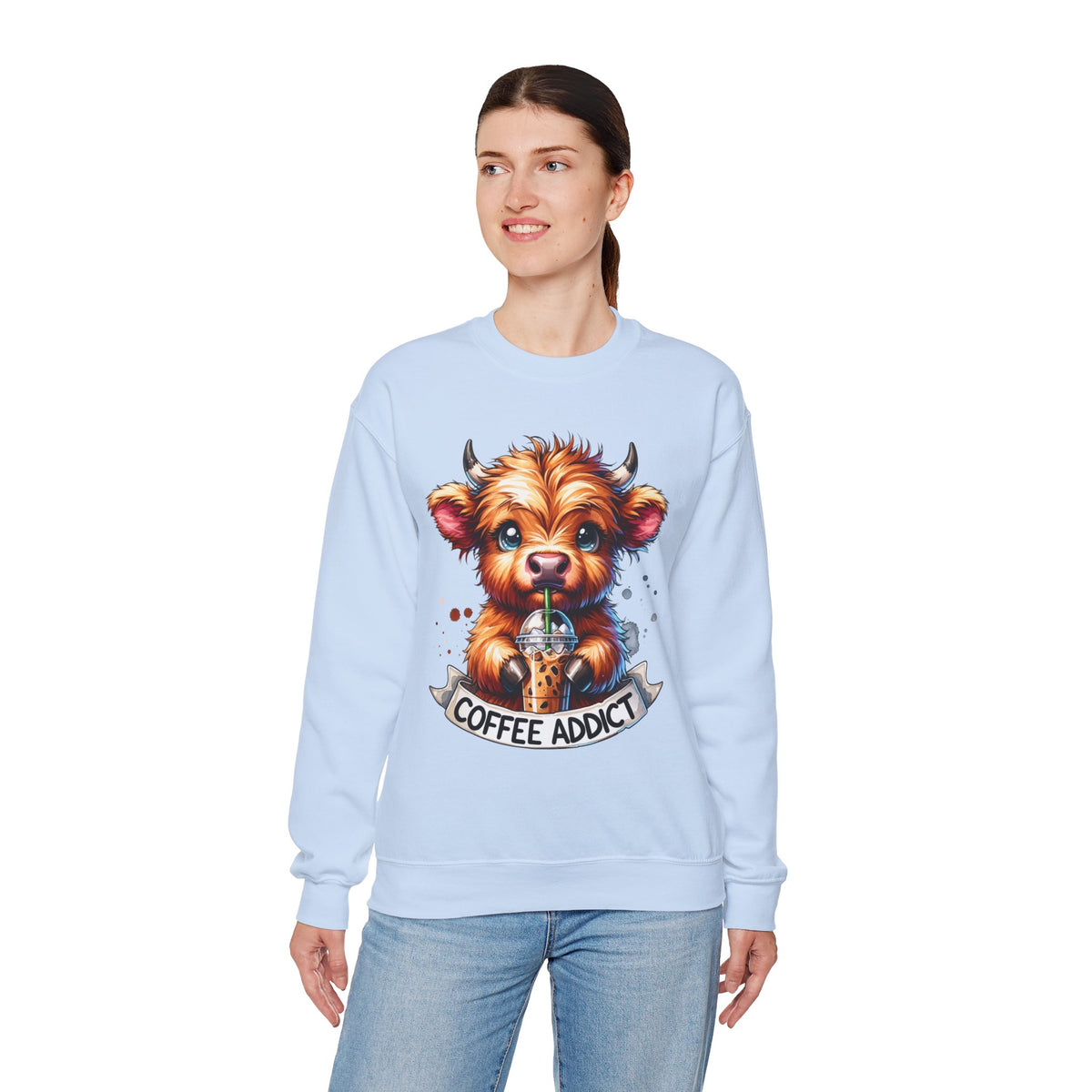 Coffee Addict Highland Cow Drinking Iced Coffee – Gildan Heavy Blend | Trendy Women’s Soft Sweatshirt. Direct to Garment. Printed & Shipped in the USA. Unisex Sizes.