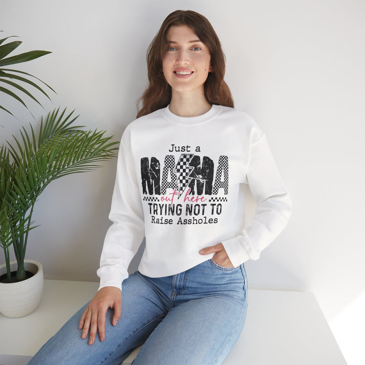 Just a Mama Out Here Trying Not To Raise Assholes – Gildan Heavy Blend | Trendy Women’s Soft Sweatshirt. Direct to Garment. Printed & Shipped in the USA. Unisex Sizes.