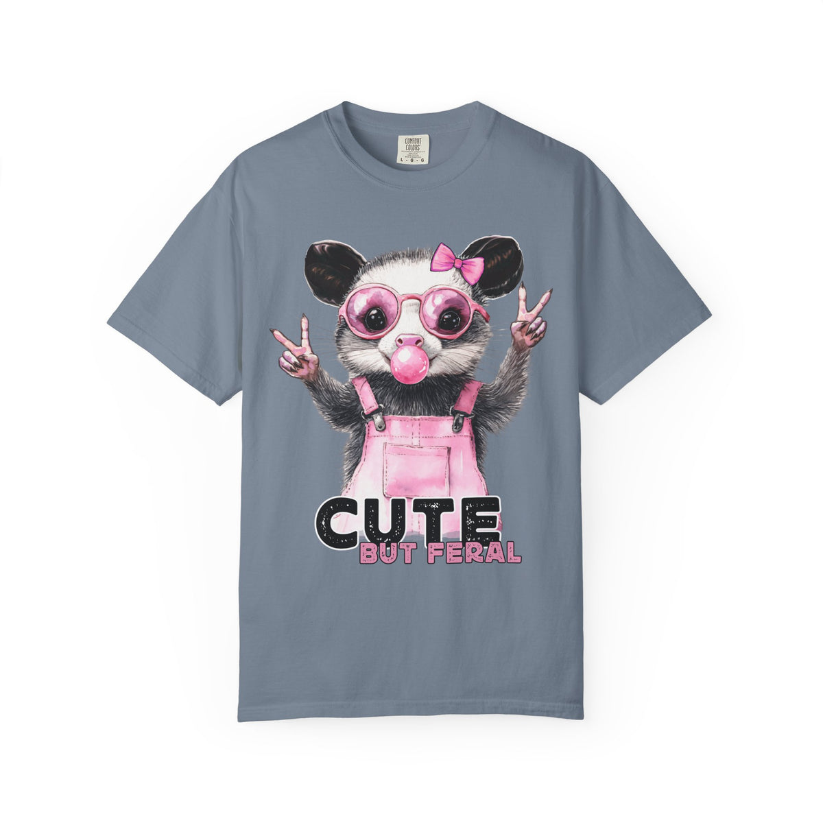 Cute But Feral, Possum in Pink Bibs - Comfort Colors | Trendy Women's T-Shirt. Direct to Garment. Printed & Shipped in the USA. Unisex Sizes.