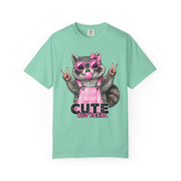 Cute But Feral, Raccoon in Pink Bibs - Comfort Colors | Trendy Women's T-Shirt. Direct to Garment. Printed & Shipped in the USA. Unisex Sizes.