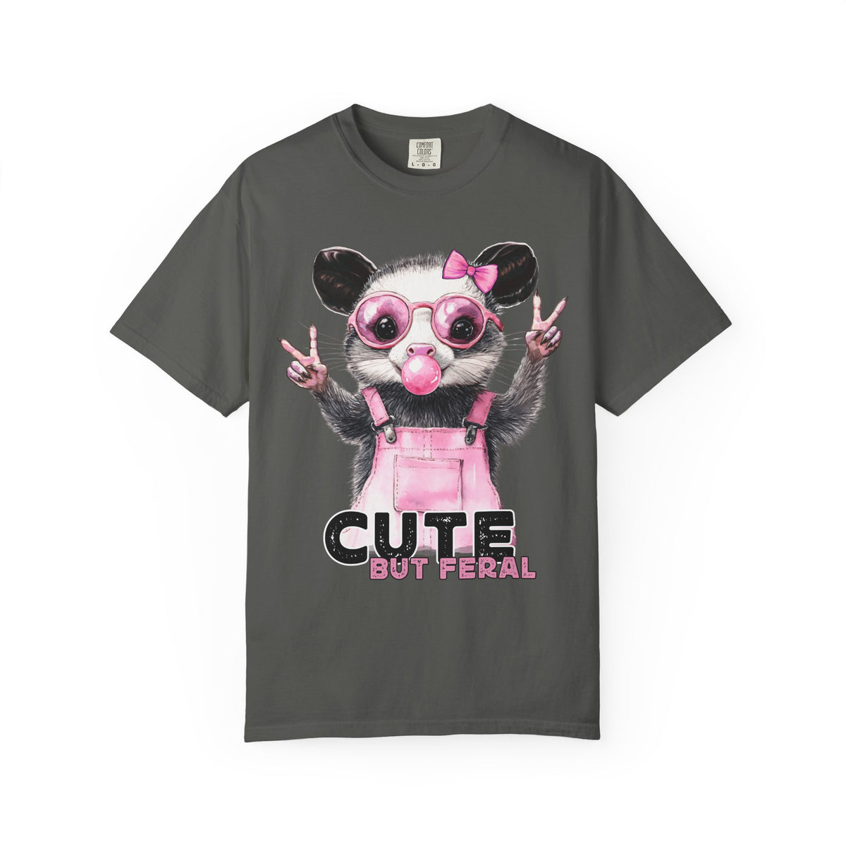 Cute But Feral, Possum in Pink Bibs - Comfort Colors | Trendy Women's T-Shirt. Direct to Garment. Printed & Shipped in the USA. Unisex Sizes.