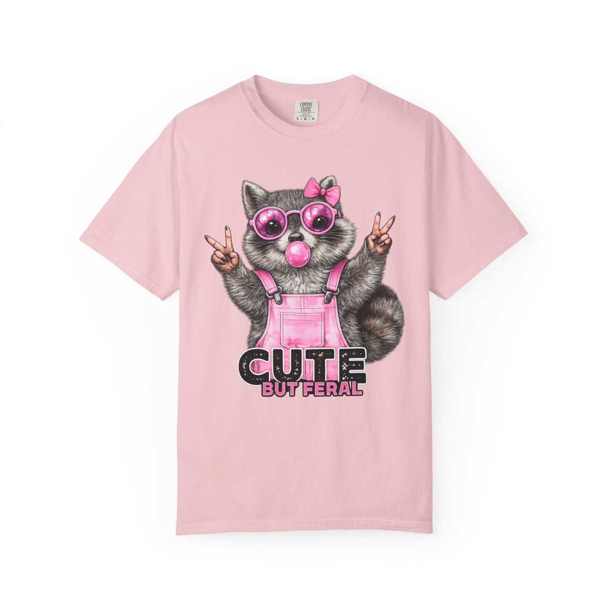 Cute But Feral, Raccoon in Pink Bibs - Comfort Colors | Trendy Women's T-Shirt. Direct to Garment. Printed & Shipped in the USA. Unisex Sizes.