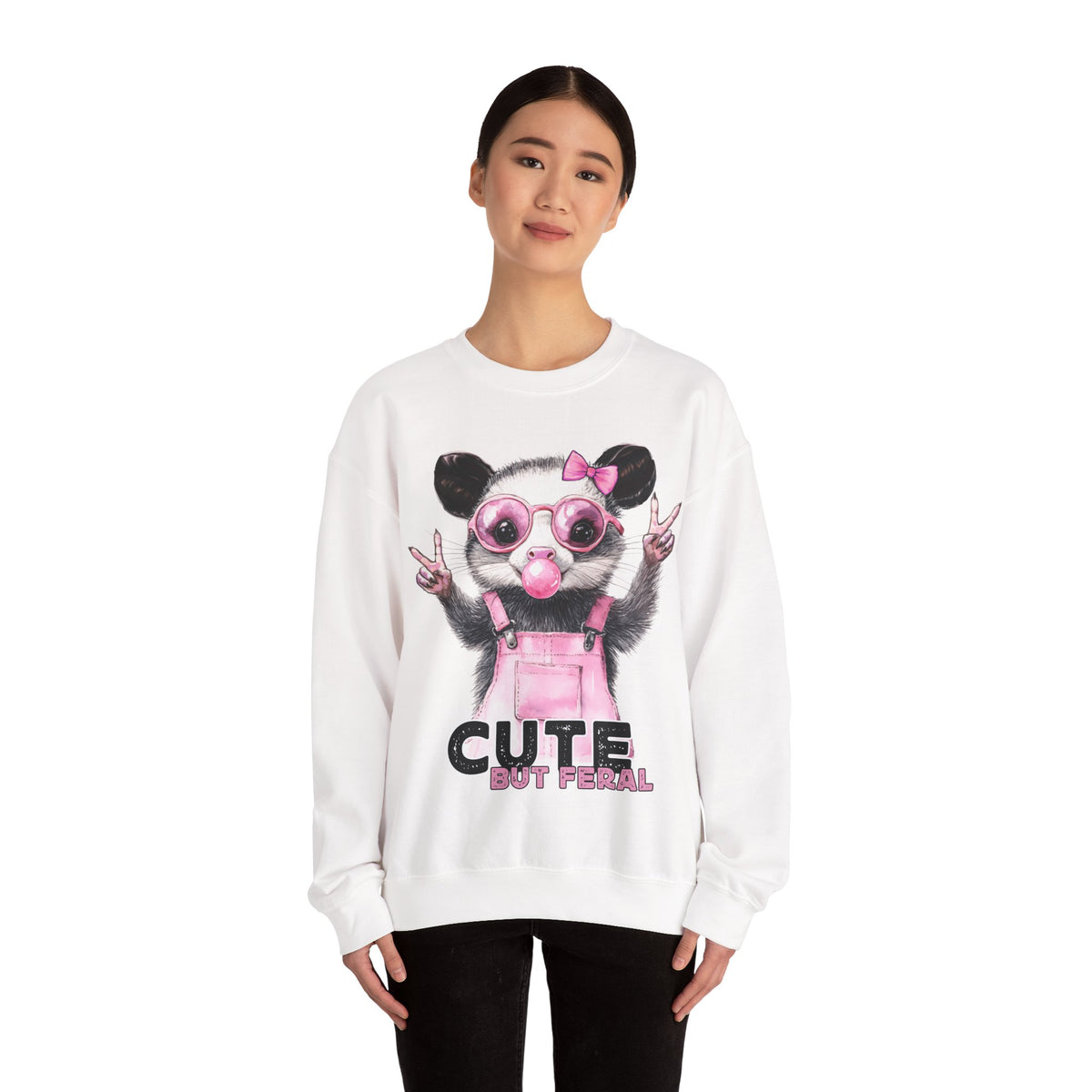 Cute But Feral, Possum in Pink Bibs – Gildan Heavy Blend | Trendy Women’s Soft Sweatshirt. Direct to Garment. Printed & Shipped in the USA. Unisex Sizes.