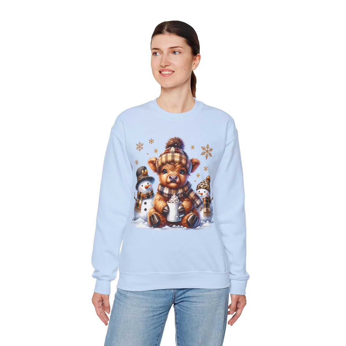 Cute Highland Cow with Snowmen, Winter – Gildan Heavy Blend | Trendy Women’s Soft Sweatshirt. Direct to Garment. Printed & Shipped in the USA. Unisex Sizes.