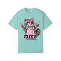 Cute But Feral, Raccoon in Pink Bibs - Comfort Colors | Trendy Women's T-Shirt. Direct to Garment. Printed & Shipped in the USA. Unisex Sizes.