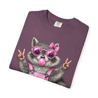 Cute But Feral, Raccoon in Pink Bibs - Comfort Colors | Trendy Women's T-Shirt. Direct to Garment. Printed & Shipped in the USA. Unisex Sizes.