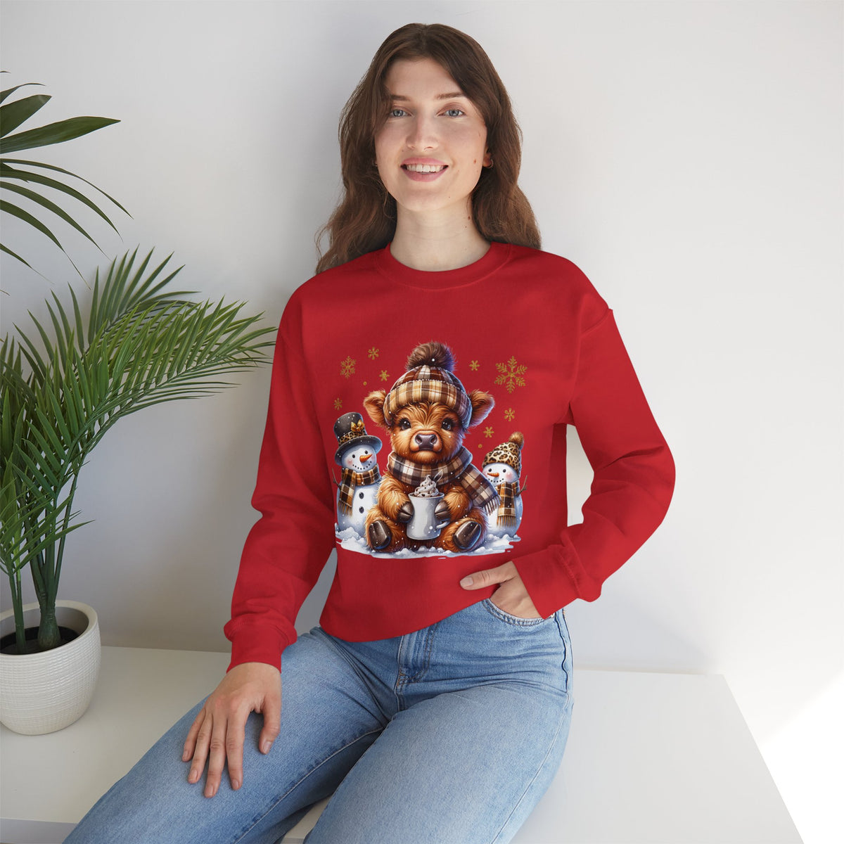Cute Highland Cow with Snowmen, Winter – Gildan Heavy Blend | Trendy Women’s Soft Sweatshirt. Direct to Garment. Printed & Shipped in the USA. Unisex Sizes.